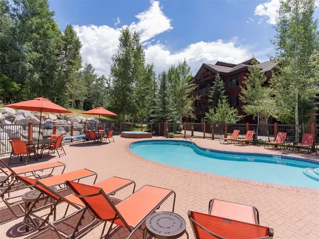 a view of a swimming pool with lounge chairs