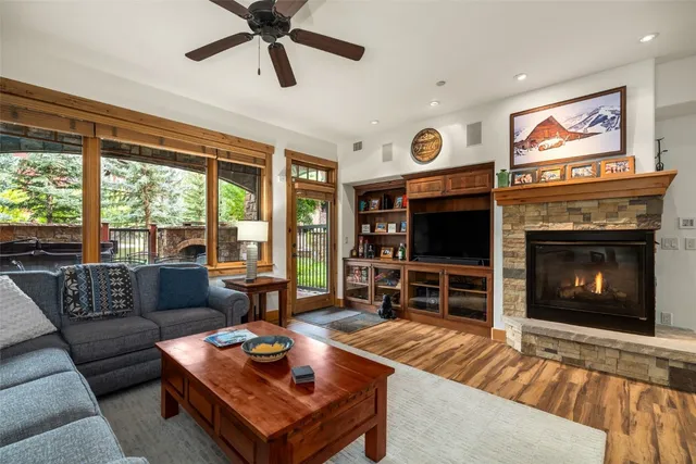 a living room with furniture a flat screen tv and a fireplace