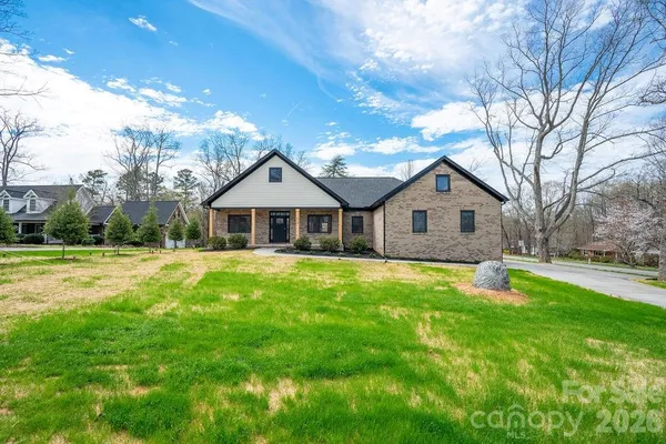a front view of a house with yard and green space