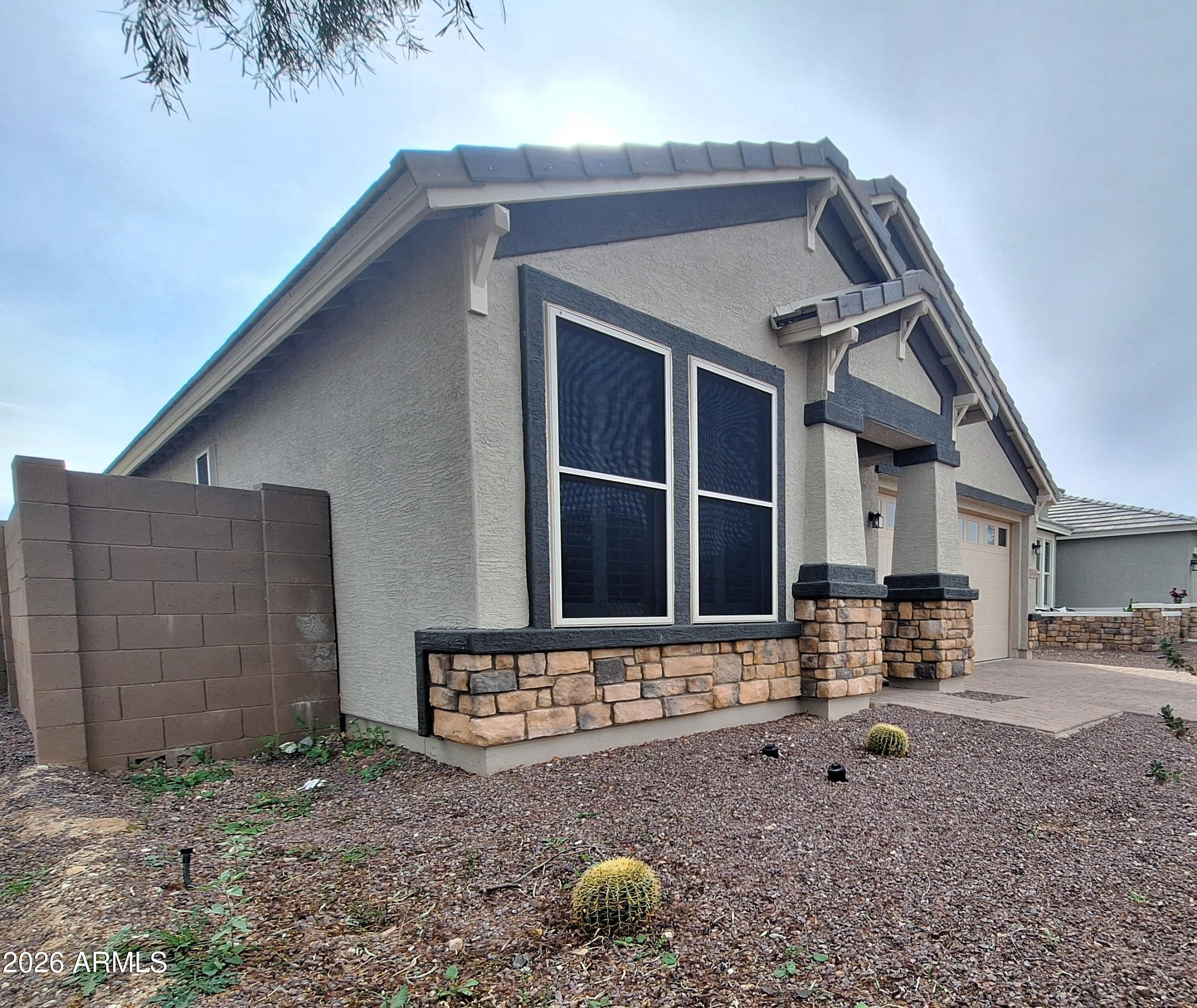 18541 West Mescal Street Surprise, AZ 85388 - Photo 3 of 31 a front view of a house with parking yard