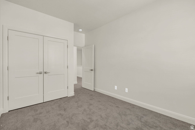 4016 South Burch Way Ogden, UT 84405 - Photo 22 of 30 Neutral wall color, grey carpet flooring, white trim, and two-panel interior doors with lever handles