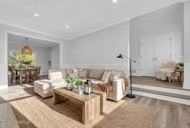 a living room with furniture and a chandelier
