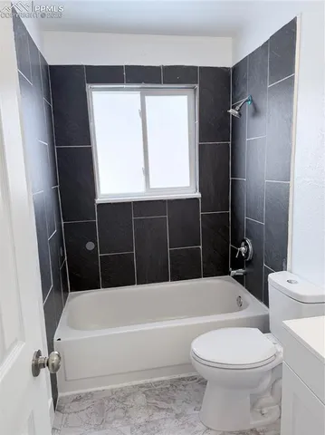 a bathroom with a bathtub toilet and sink