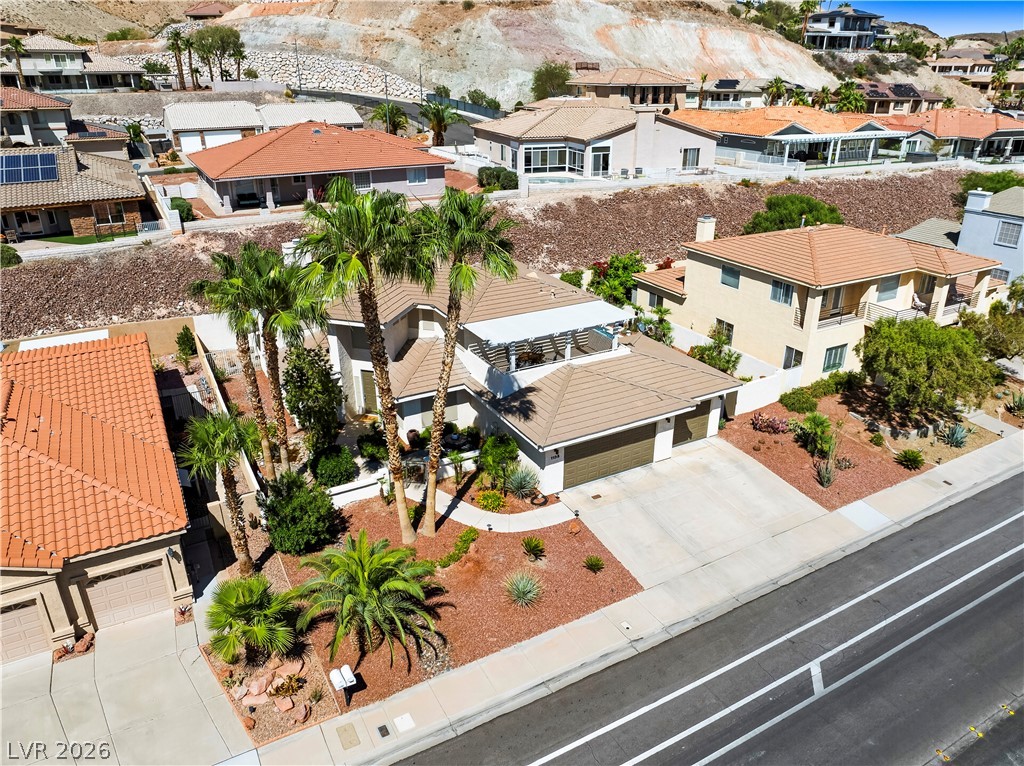 1135 Calico Ridge Drive Henderson, NV 89011 - Photo 55 of 86 Palm trees frame this home's inviting facade, set against a dramatic desert hillside backdrop.