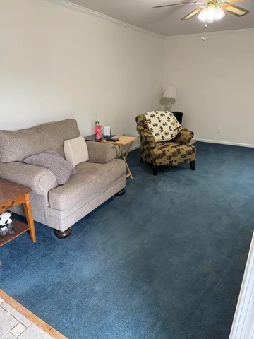 a living room with furniture and a chandelier