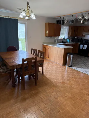 a view of a dining room with furniture and chandelier