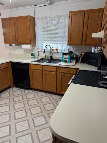 a kitchen with a sink a stove and cabinets