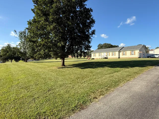 a view of a swimming pool and a yard