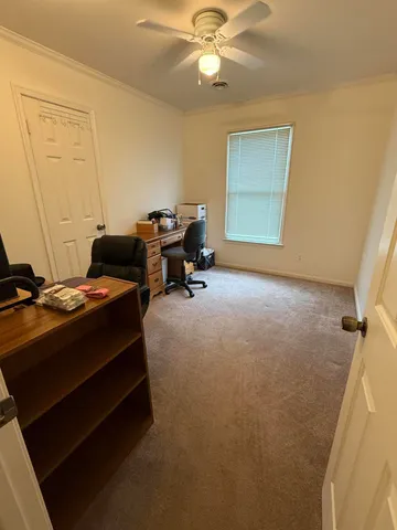 a bed room with a bed and a ceiling fan