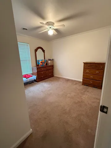 a room with a bed and a dresser