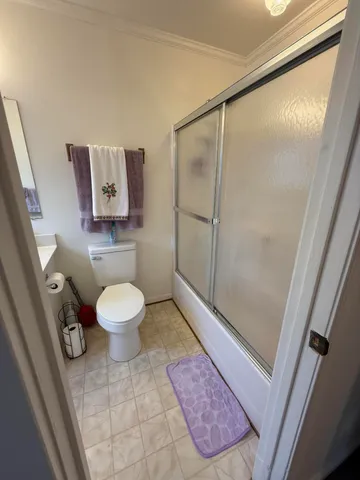 a bathroom with a toilet and a shower