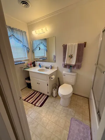a bathroom with a toilet sink and mirror