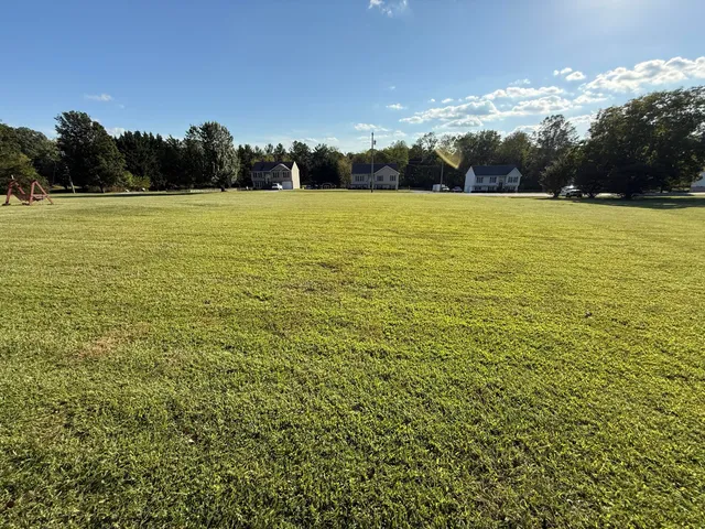 a view of outdoor space with swimming pool and trees in the background