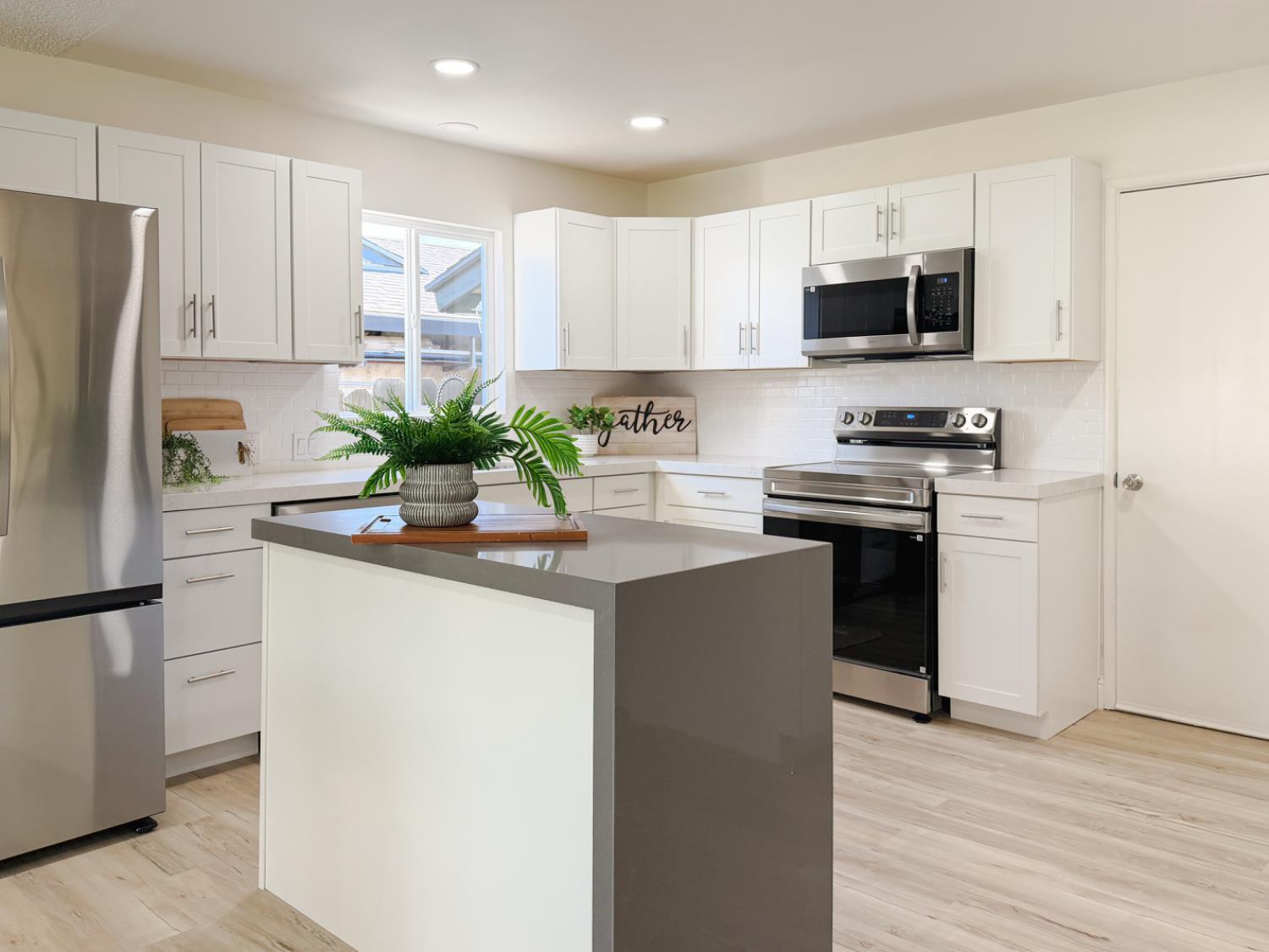 878 Carol Avenue Merced, CA 95341 - Photo 11 of 41 a kitchen with stainless steel appliances granite countertop a refrigerator a stove a microwave and cabinets