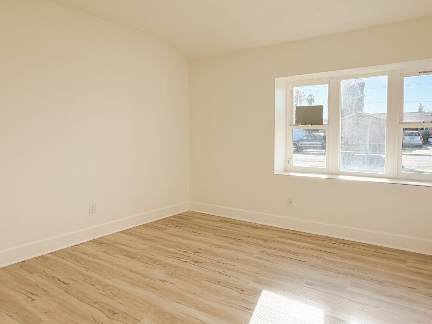 878 Carol Avenue Merced, CA 95341 - Photo 20 of 41 wooden floor in an empty room with a window