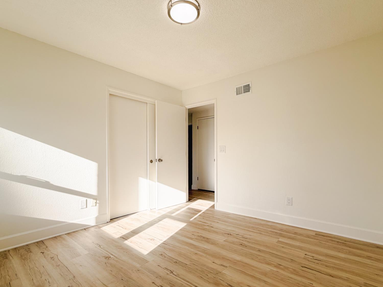 878 Carol Avenue Merced, CA 95341 - Photo 21 of 41 a view of an empty room with wooden floor