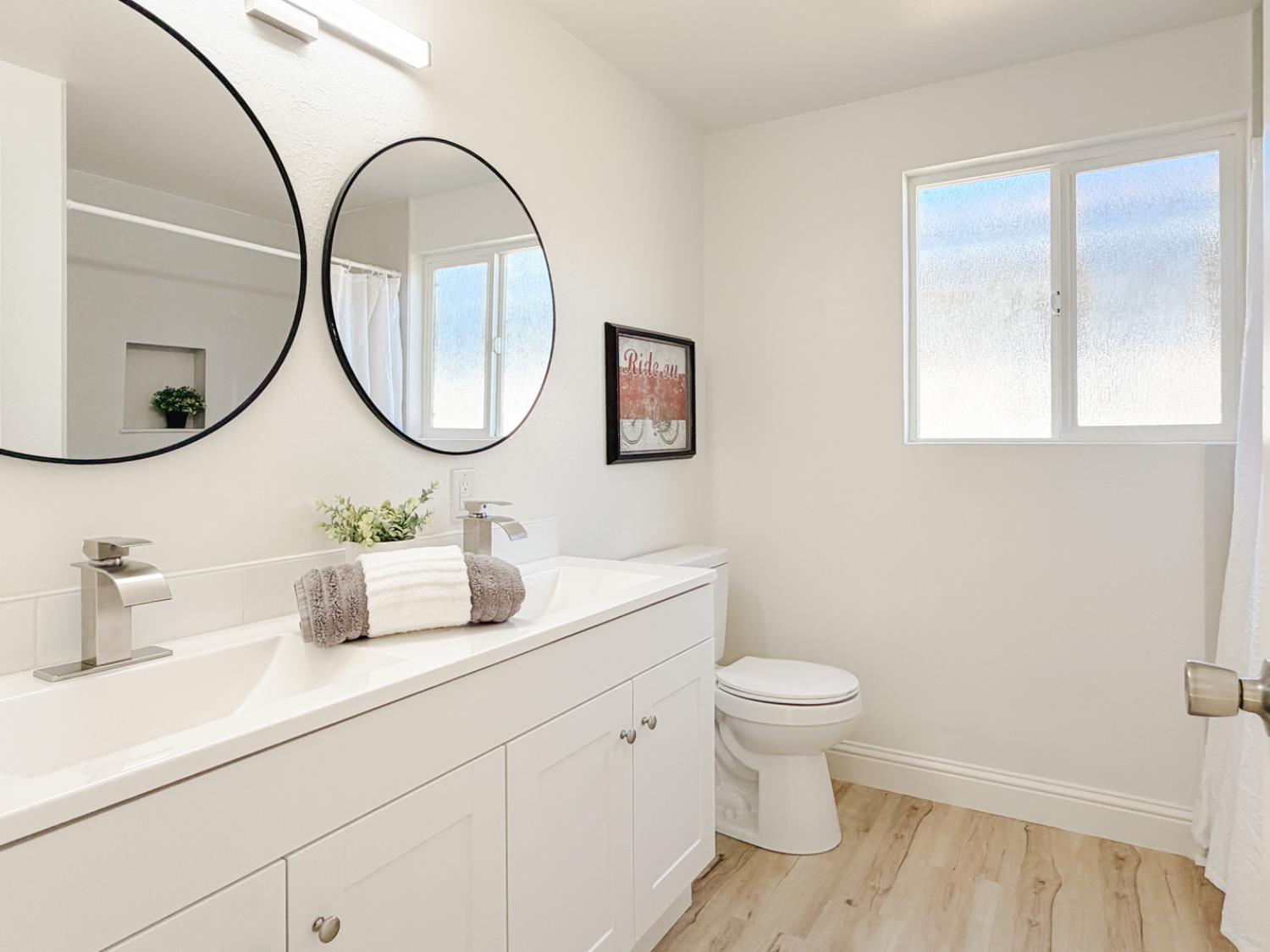 878 Carol Avenue Merced, CA 95341 - Photo 25 of 41 a bathroom with a toilet sink and mirror