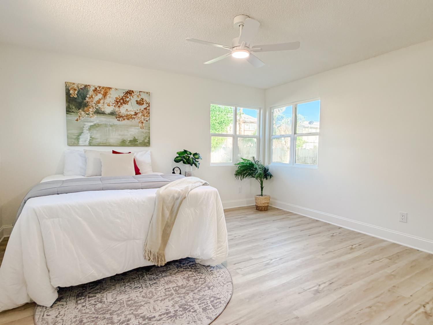 878 Carol Avenue Merced, CA 95341 - Photo 29 of 41 a spacious bedroom with a bed and a chandelier
