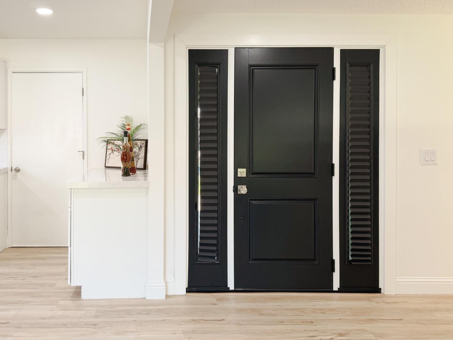878 Carol Avenue Merced, CA 95341 - Photo 4 of 41 a view of a hallway with wooden floor and staircase