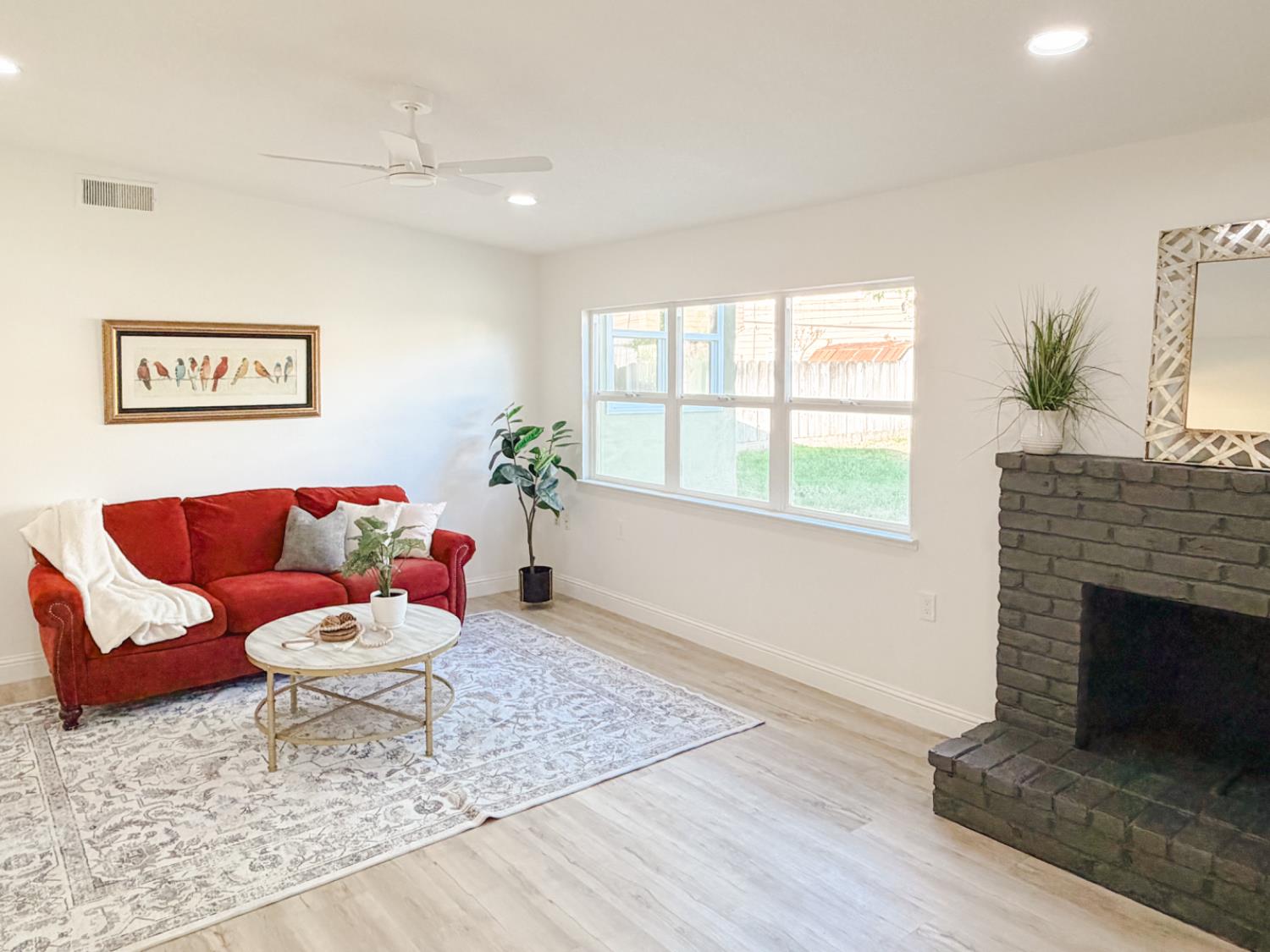 878 Carol Avenue Merced, CA 95341 - Photo 5 of 41 a living room with furniture and a fireplace