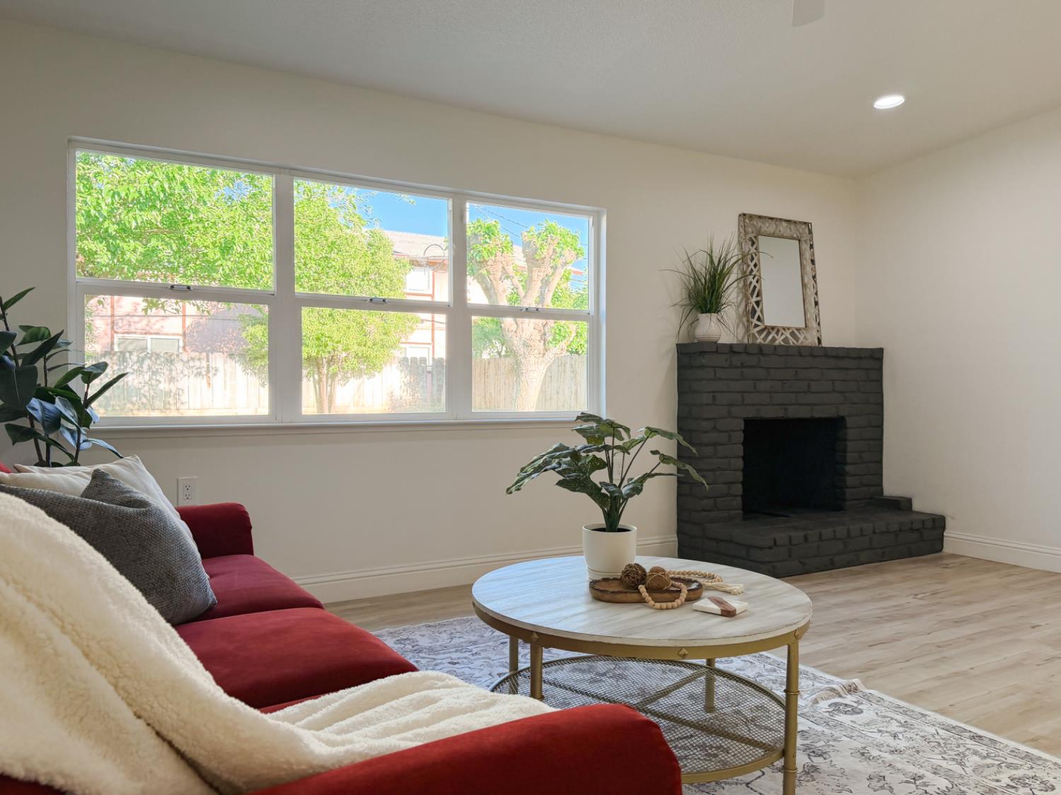 878 Carol Avenue Merced, CA 95341 - Photo 6 of 41 a living room with furniture a fireplace and a table