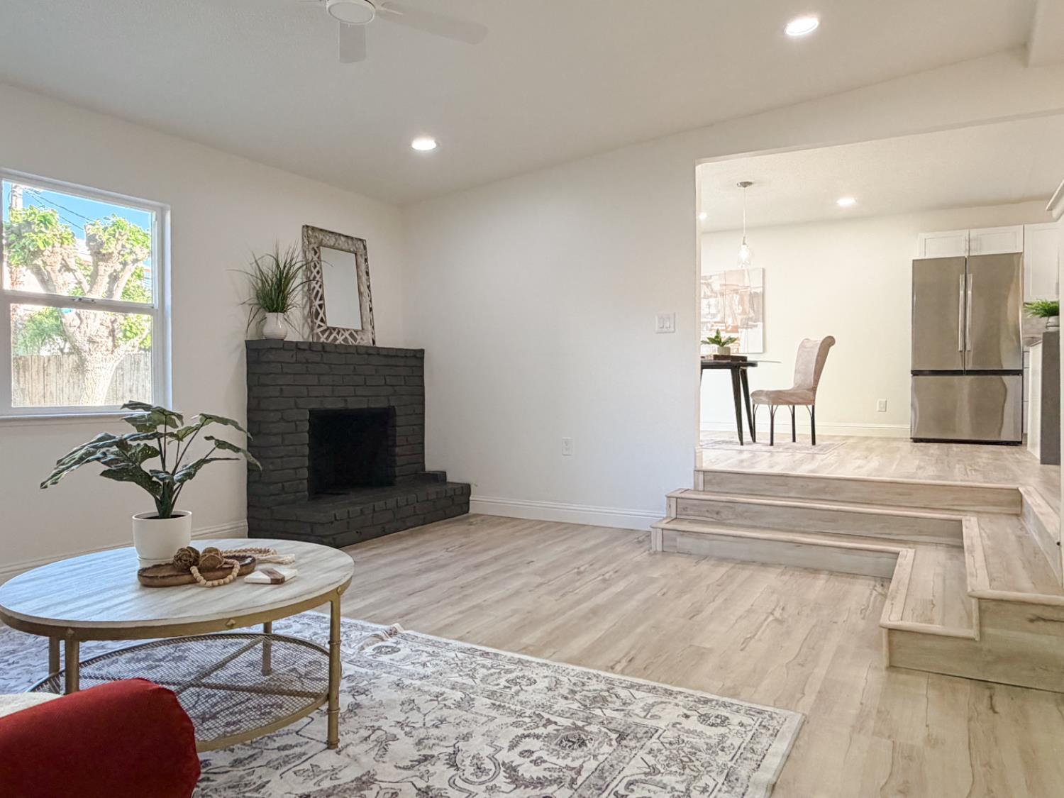 878 Carol Avenue Merced, CA 95341 - Photo 7 of 41 a living room with furniture a fireplace and a table