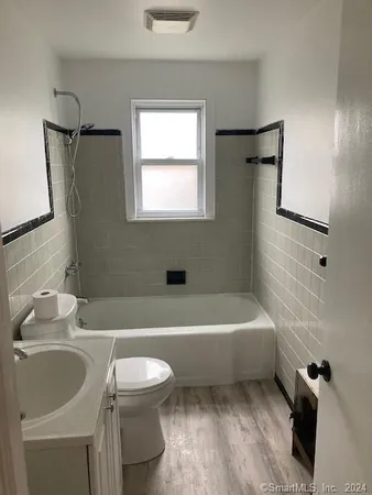 a bathroom with a sink a toilet and a bathtub