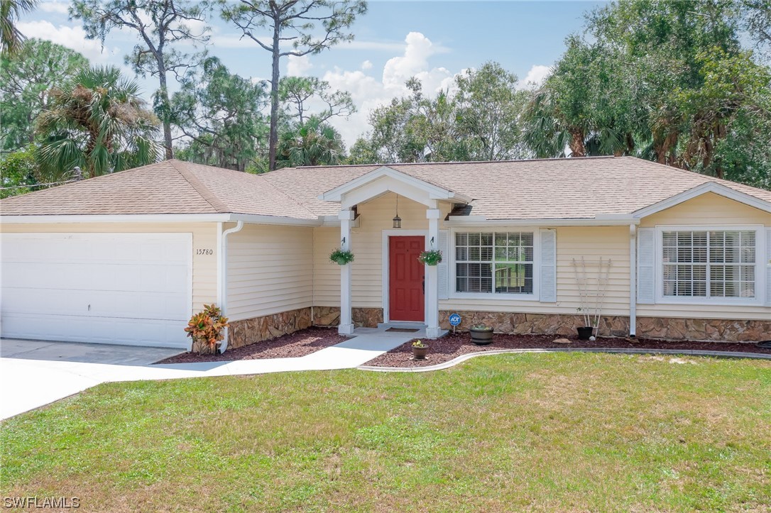 15780 Cemetery Road Fort Myers, FL 33905 - Photo 1 of 39 a front view of a house with a garden and swimming pool