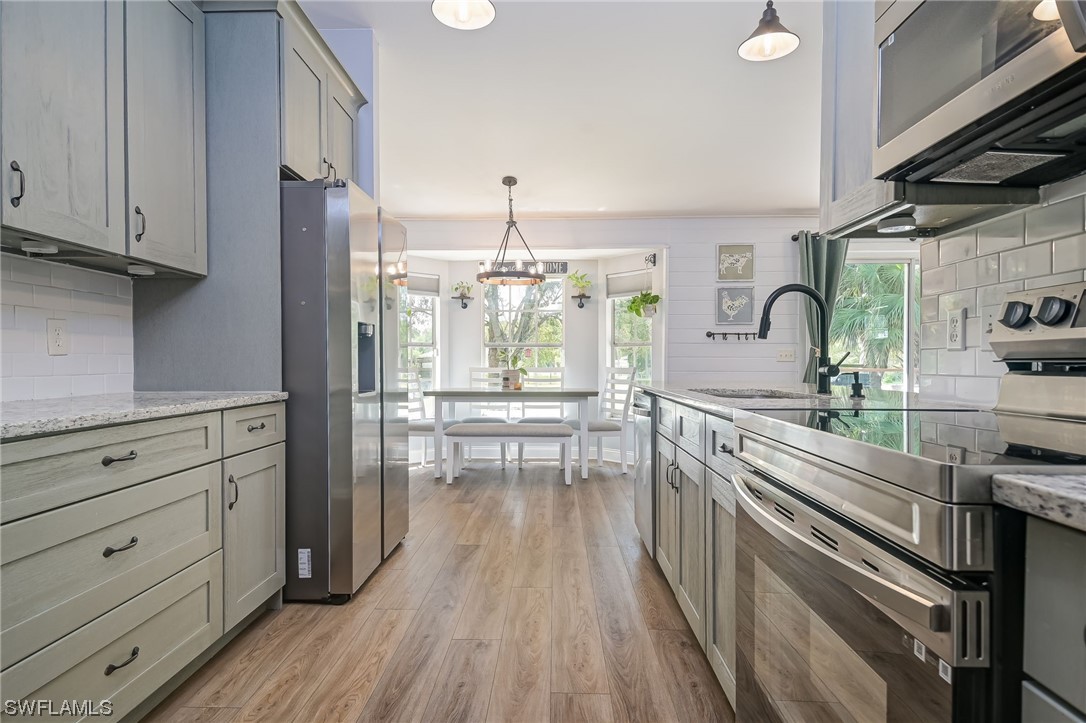 15780 Cemetery Road Fort Myers, FL 33905 - Photo 12 of 39 a kitchen with stainless steel appliances kitchen island granite countertop a stove and a sink