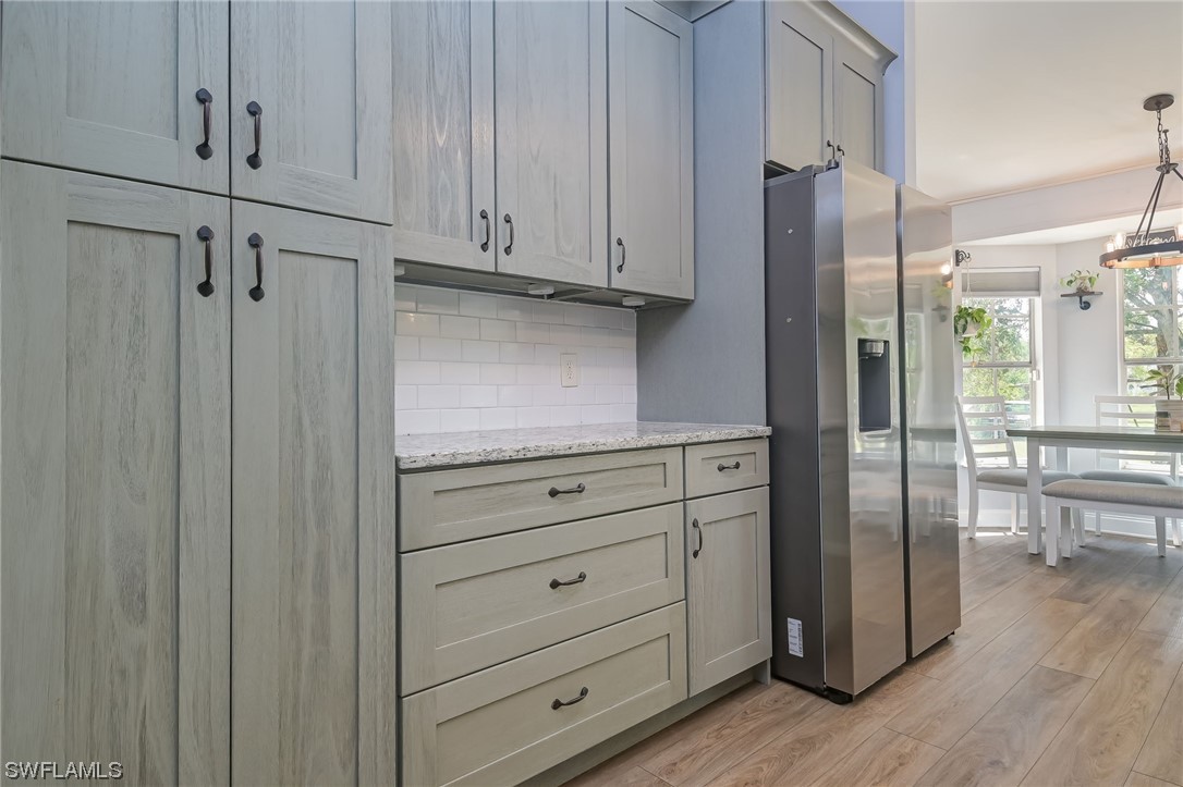 15780 Cemetery Road Fort Myers, FL 33905 - Photo 13 of 39 a kitchen with stainless steel appliances granite countertop cabinets and wooden floor