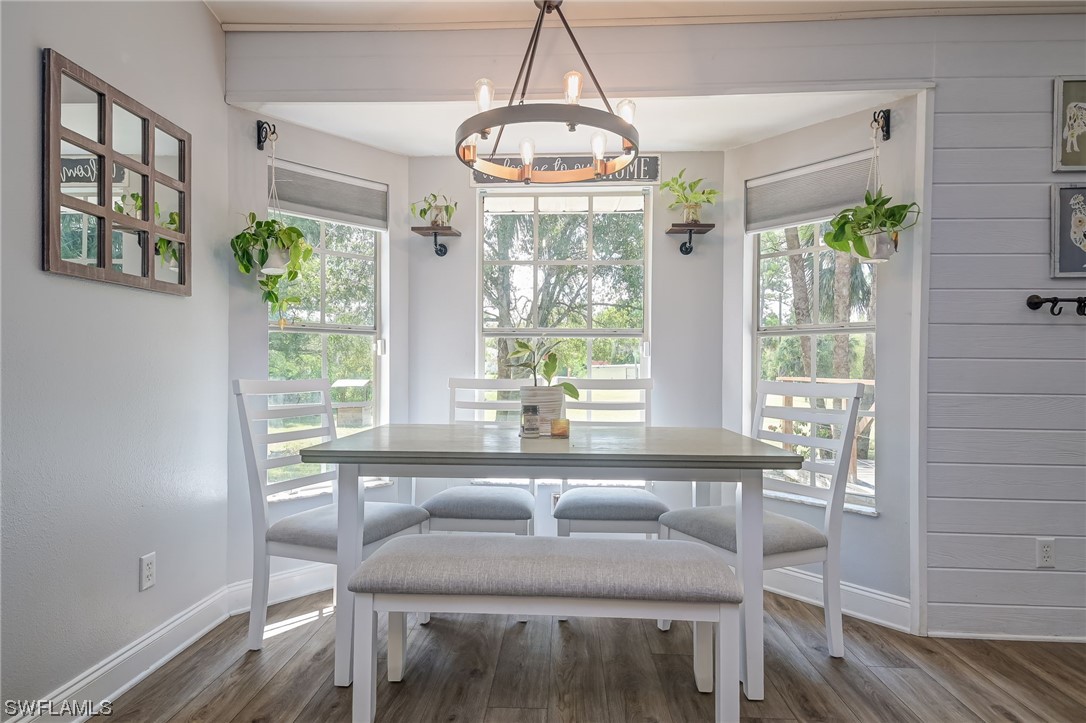 15780 Cemetery Road Fort Myers, FL 33905 - Photo 15 of 39 a view of a dining room with furniture a chandelier and wooden floor