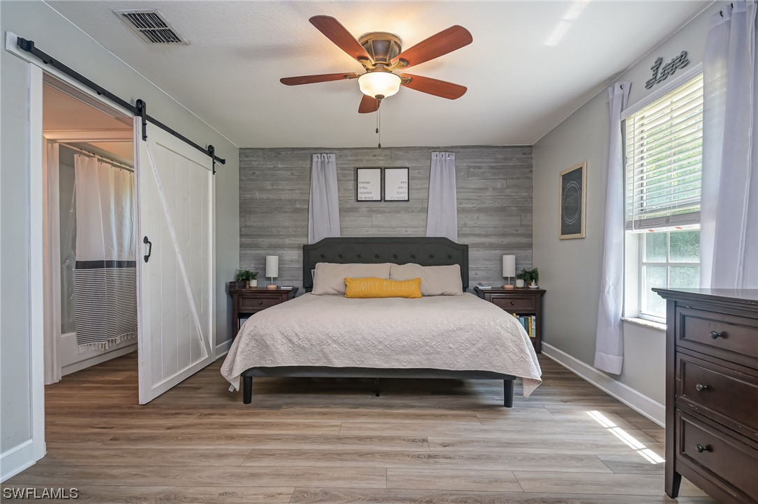 15780 Cemetery Road Fort Myers, FL 33905 - Photo 16 of 39 a bedroom with a bed and wooden floor