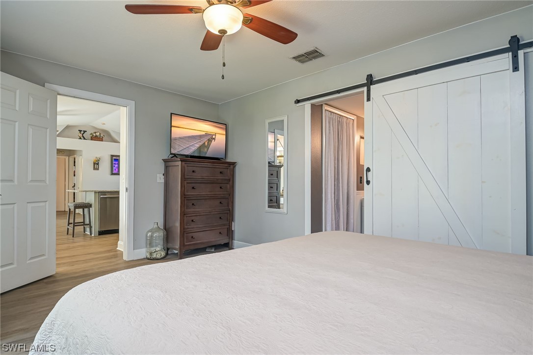 15780 Cemetery Road Fort Myers, FL 33905 - Photo 17 of 39 a bedroom with a bed and a chandelier