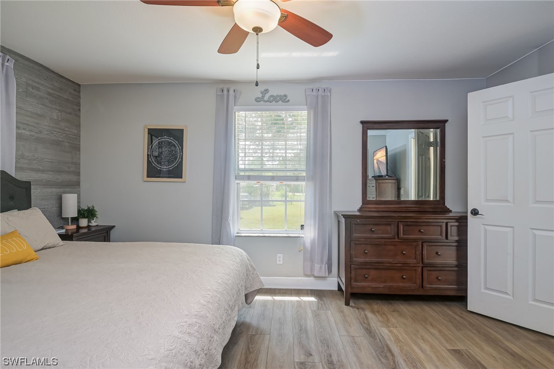 15780 Cemetery Road Fort Myers, FL 33905 - Photo 18 of 39 a bedroom with a bed and wooden floor