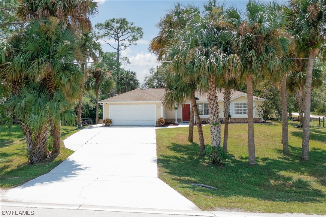 15780 Cemetery Road Fort Myers, FL 33905 - Photo 2 of 39 a swimming pool with yard and outdoor seating