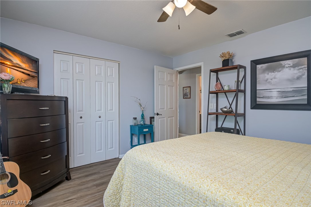 15780 Cemetery Road Fort Myers, FL 33905 - Photo 21 of 39 a bedroom with a bed and a chandelier