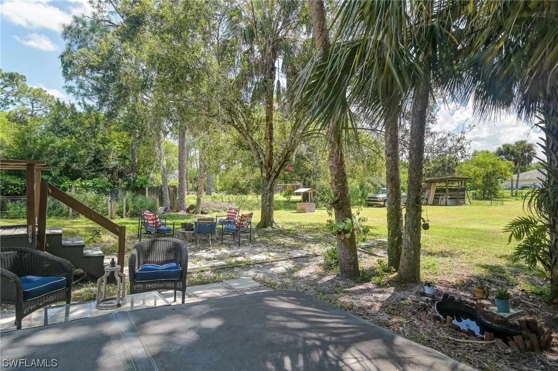15780 Cemetery Road Fort Myers, FL 33905 - Photo 30 of 39 a view of a yard with swimming pool and sitting area