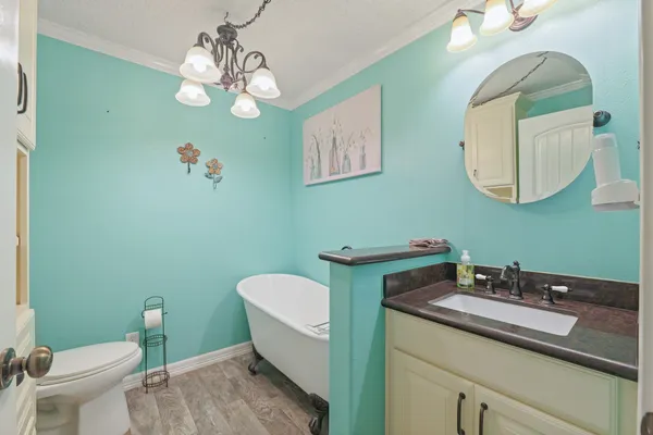 a bathroom with a toilet a sink and mirror