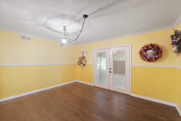a view of a room with wooden floor and small space