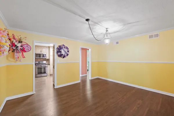 a view of a room with wooden floor and natural light