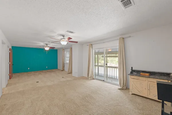 a view of a kitchen with an empty room and kitchen view