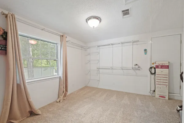 a view of a livingroom with an empty space and a window