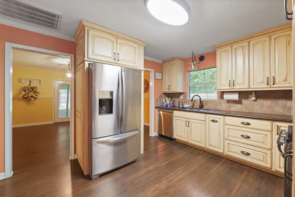 a kitchen with stainless steel appliances a refrigerator sink and cabinets