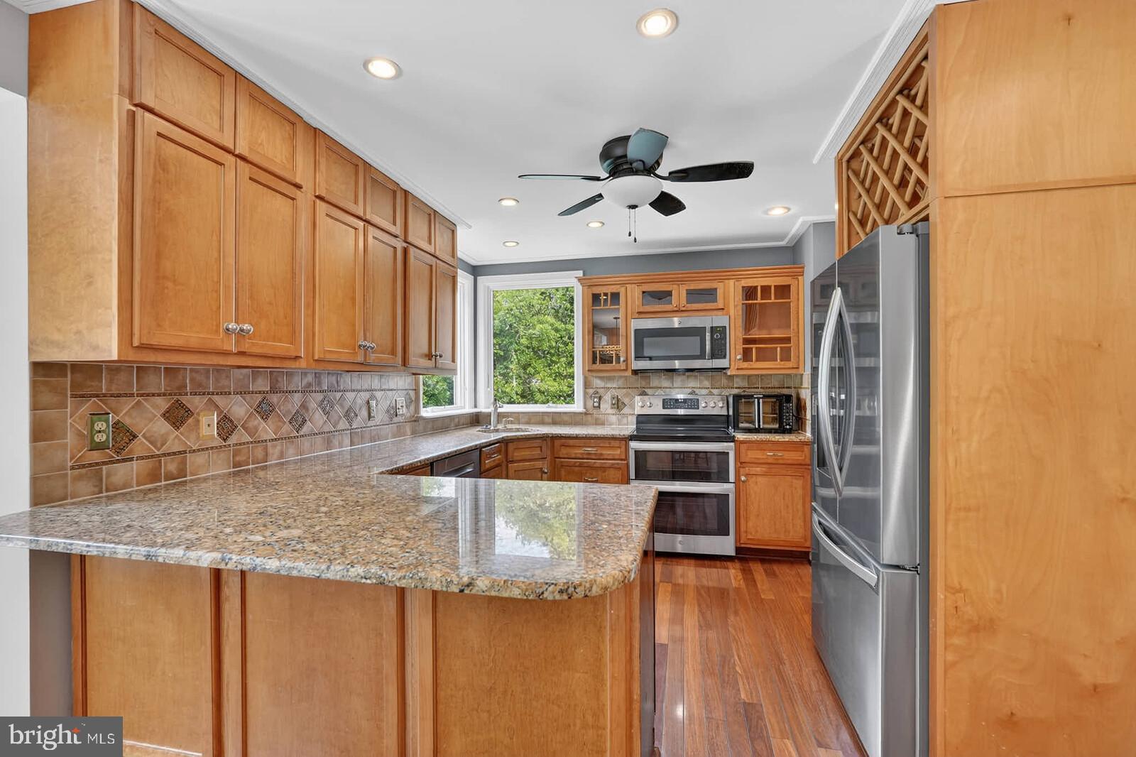 2108 Merrifields Drive Silver Spring, MD 20906 - Photo 12 of 69 a kitchen with stainless steel appliances granite countertop a refrigerator and a sink