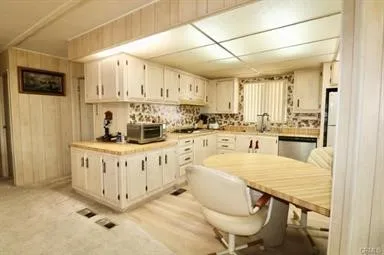 a kitchen with stainless steel appliances granite countertop a white cabinets and a refrigerator