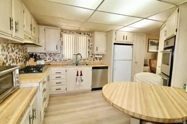 a kitchen with a stove a refrigerator and a fireplace