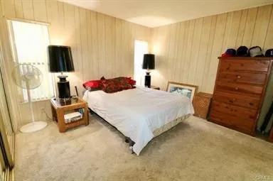 a bedroom with a bed and a flat tv screen