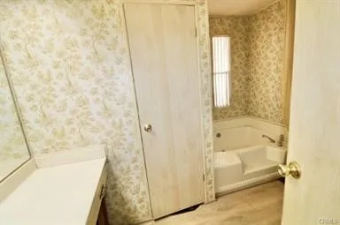 a bathroom with a tub and shower