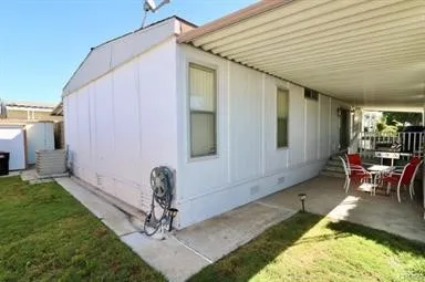 a backyard of a house with table and chairs