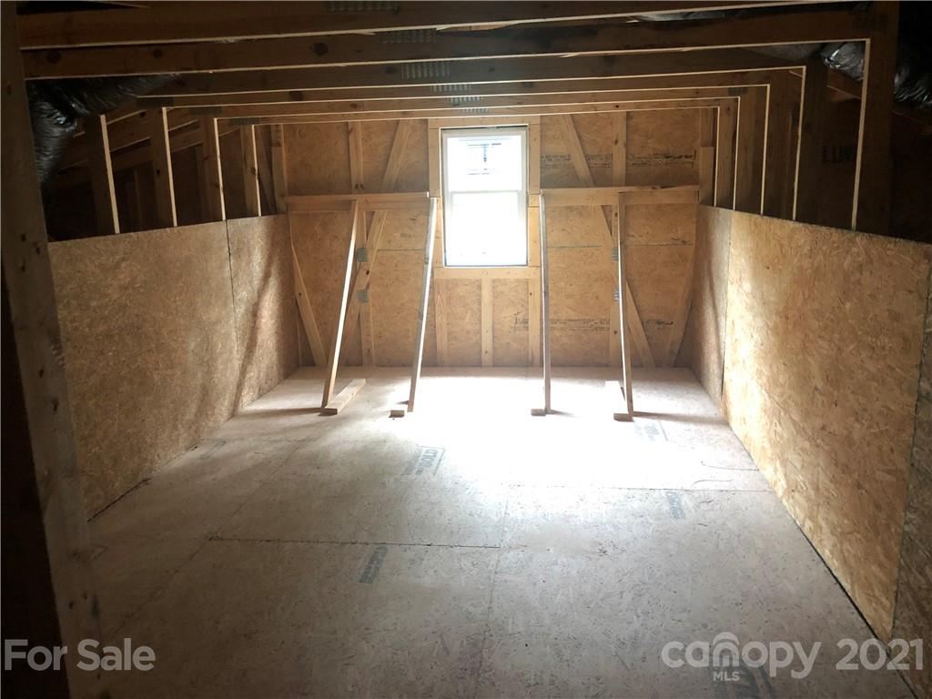5520 Closeburn Road Charlotte, NC 28210 - Photo 29 of 32 a view of an empty room with wooden floor and a fan